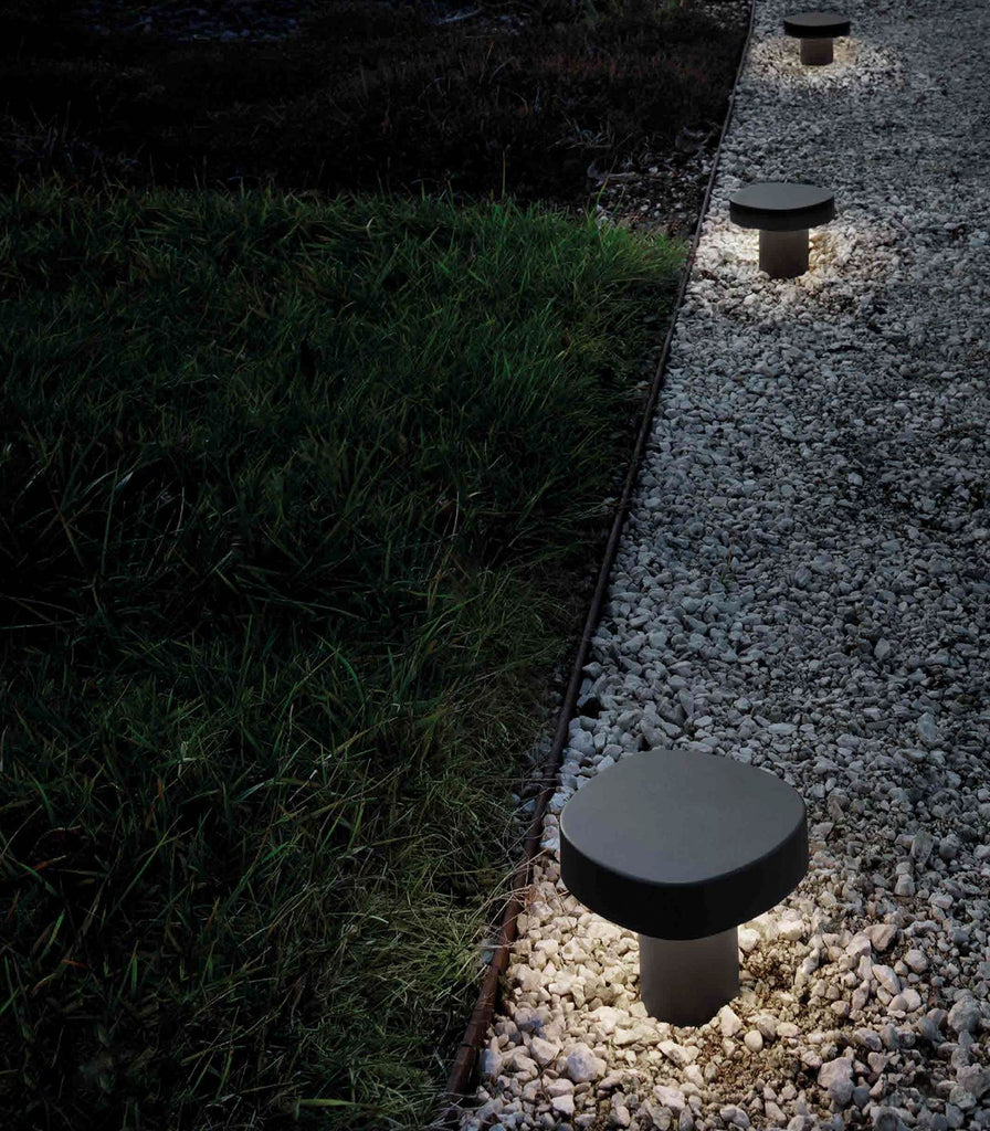 Ai Lati Ciottolo Bollard Light featured within a outdoor space