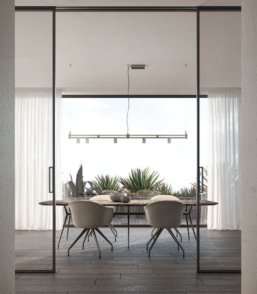 Karman Airtek One Linear Pendant Light hanging over dining table