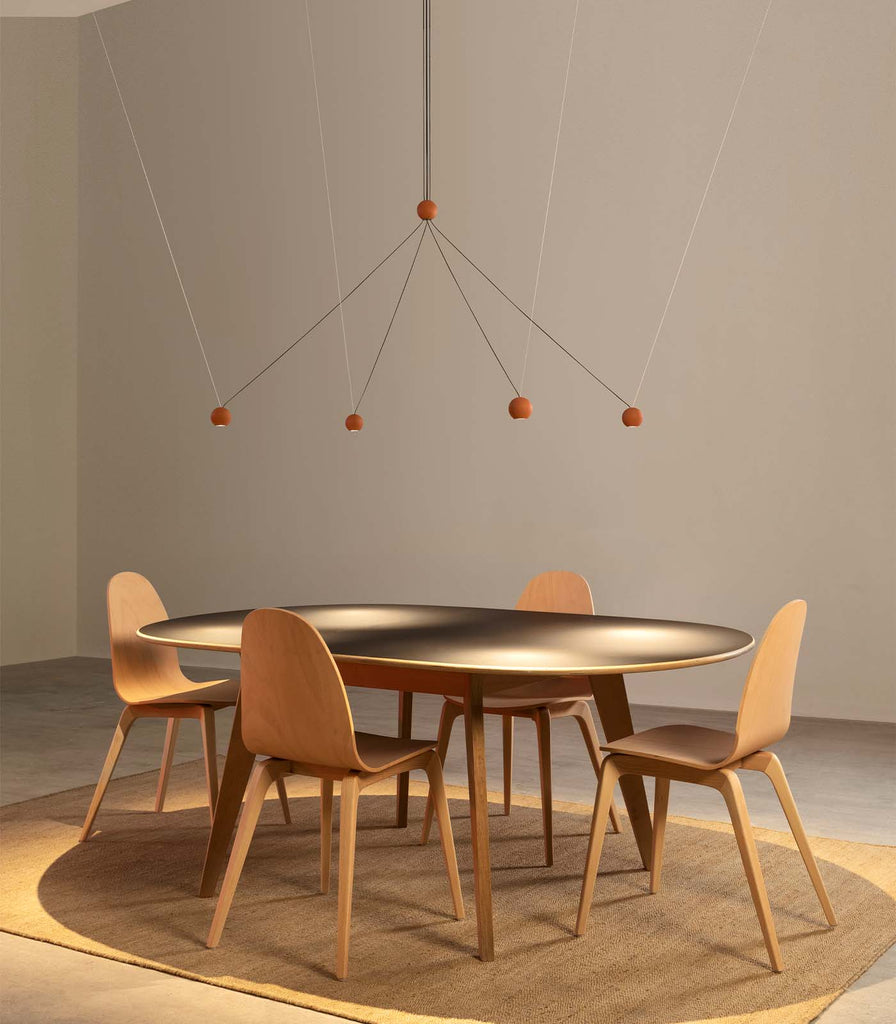 Lighterior Compass Cluster Pendant Light hanging over dining table
