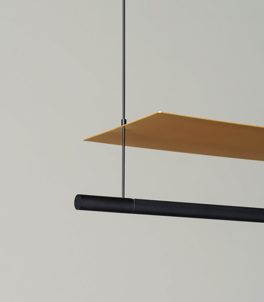 Santa & Cole Lamina Dorada Pendant Light featured within interior space