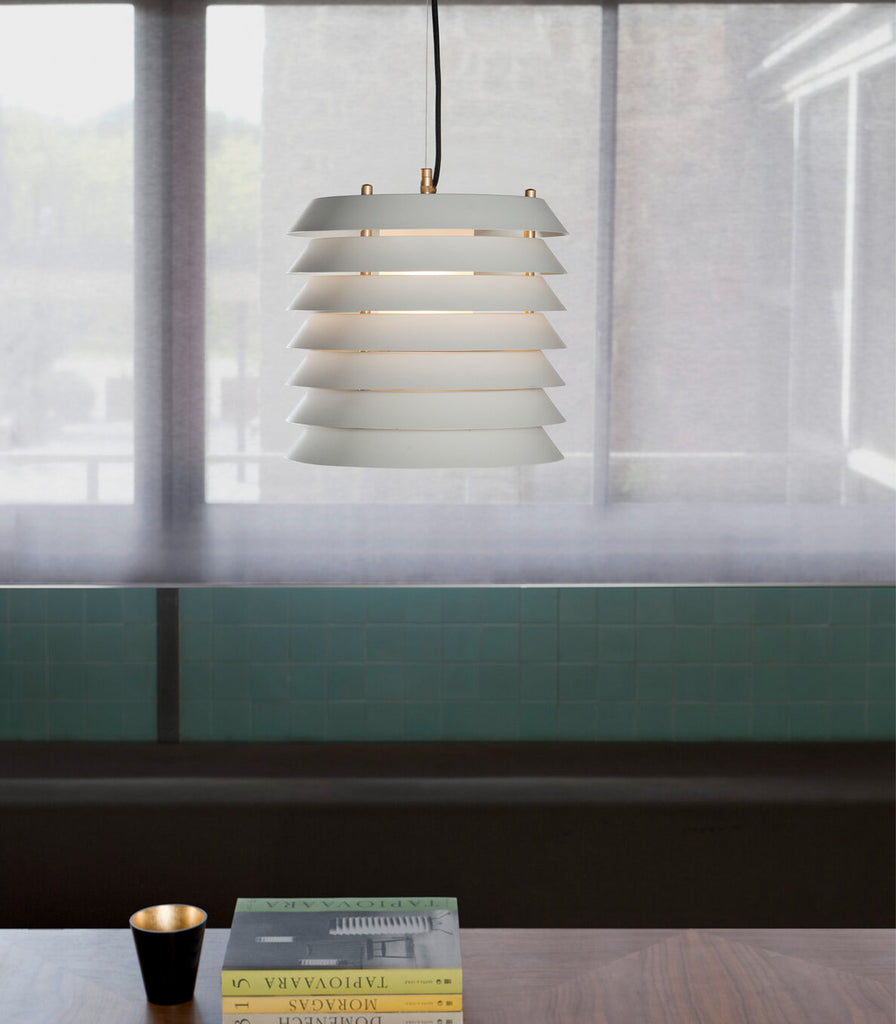 Santa & Cole Maija Pendant Light hanging over dining table