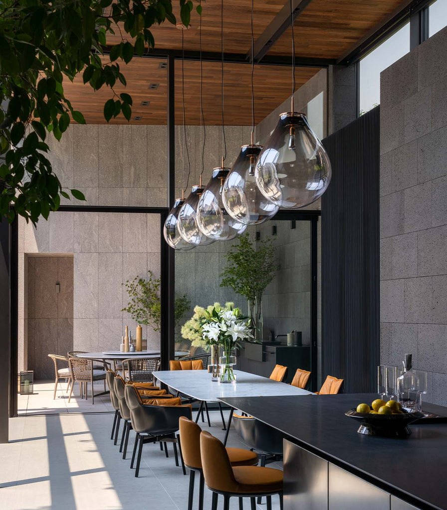 Bomma Tim Copper Pendant Light hanging in a dining table