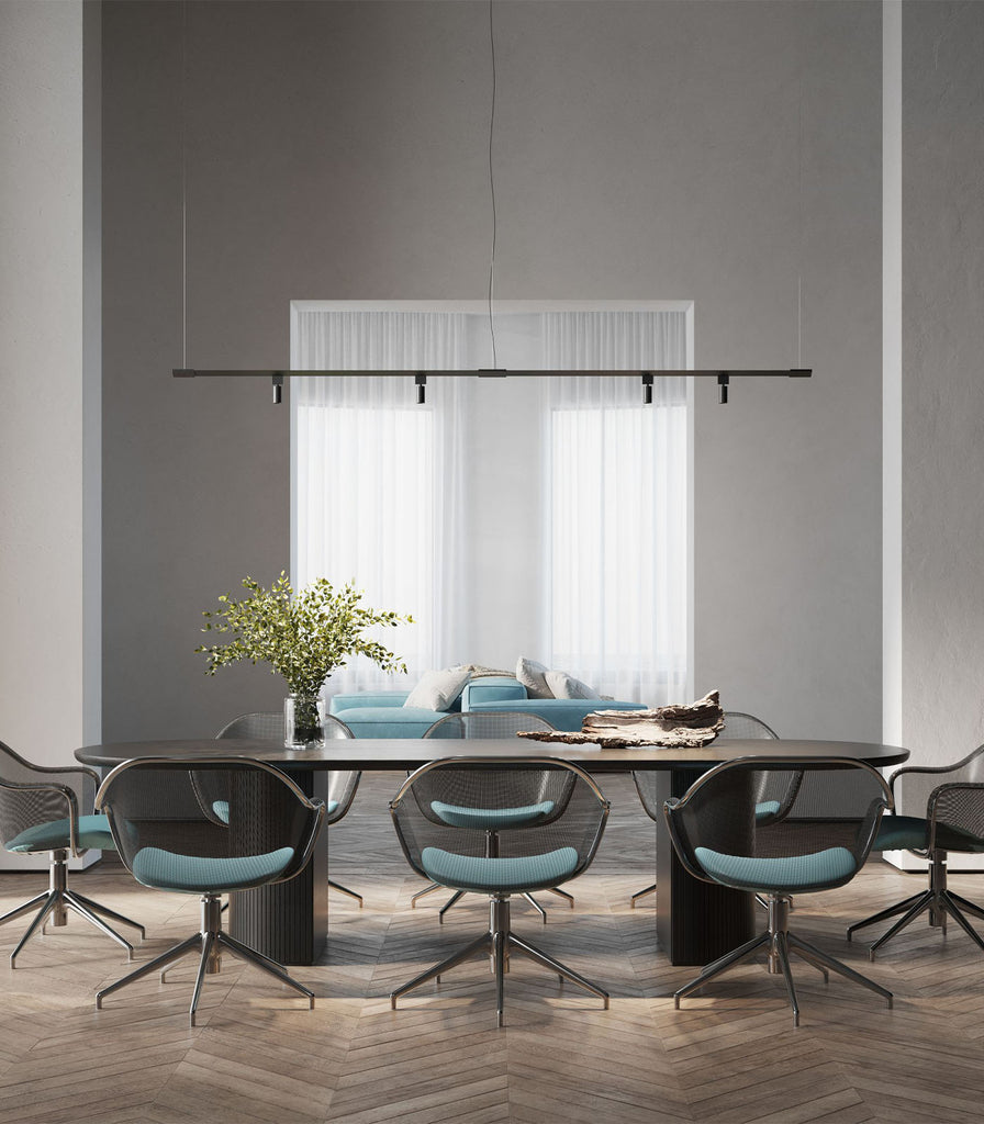 Karman Turn It Linear Pendant Light hanging over dining table