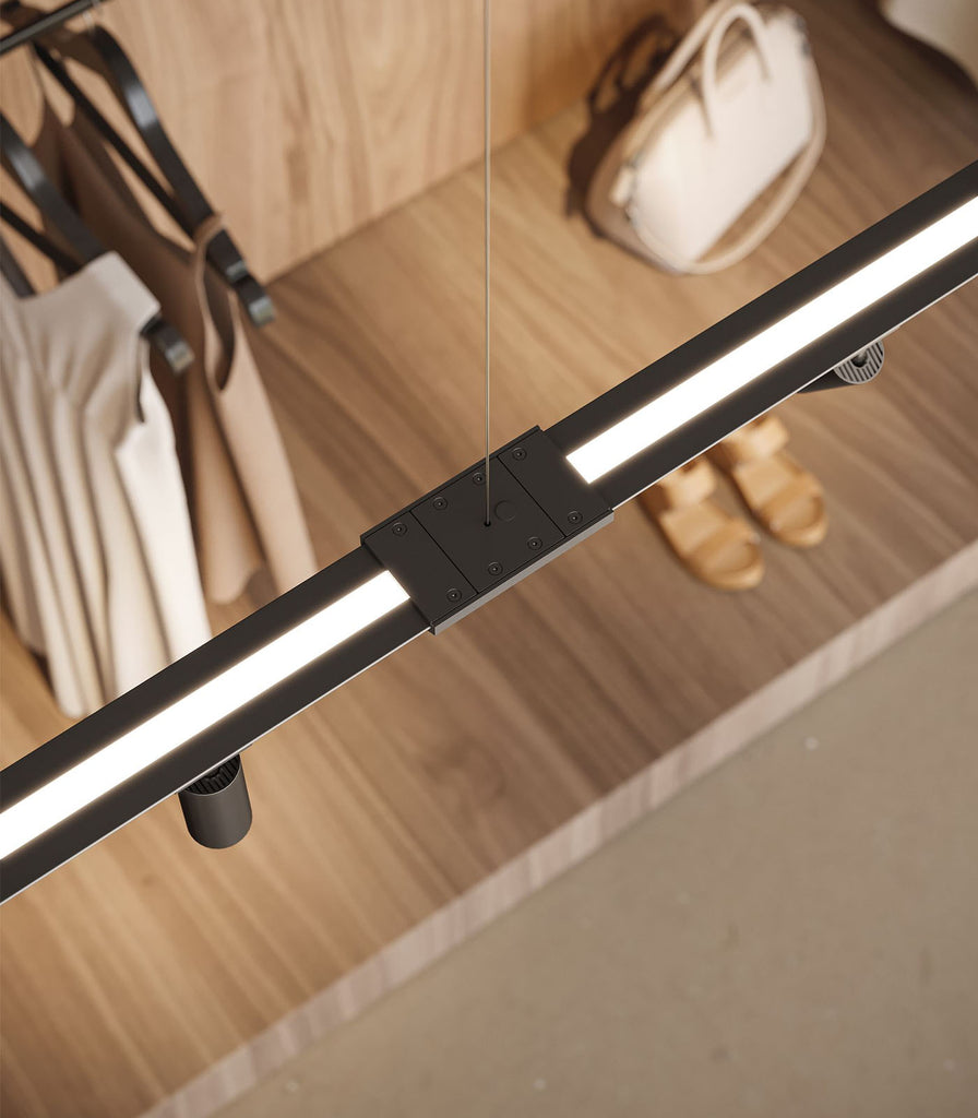 Karman Turn It Linear Pendant Light featured within interior space