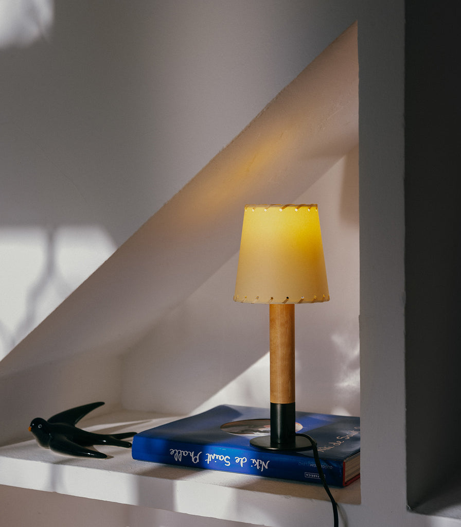 Santa & Cole Basica Minima Table Lamp featured within interior space