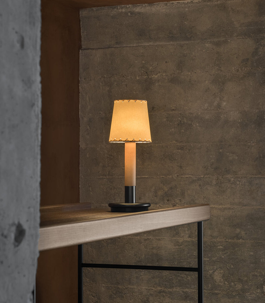 Santa & Cole Basica Minima Portable Table Lamp featured within interior space