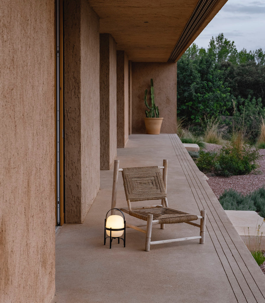 Santa & Cole Cestita Alubat Portable Table Lamp featured within outdoor space