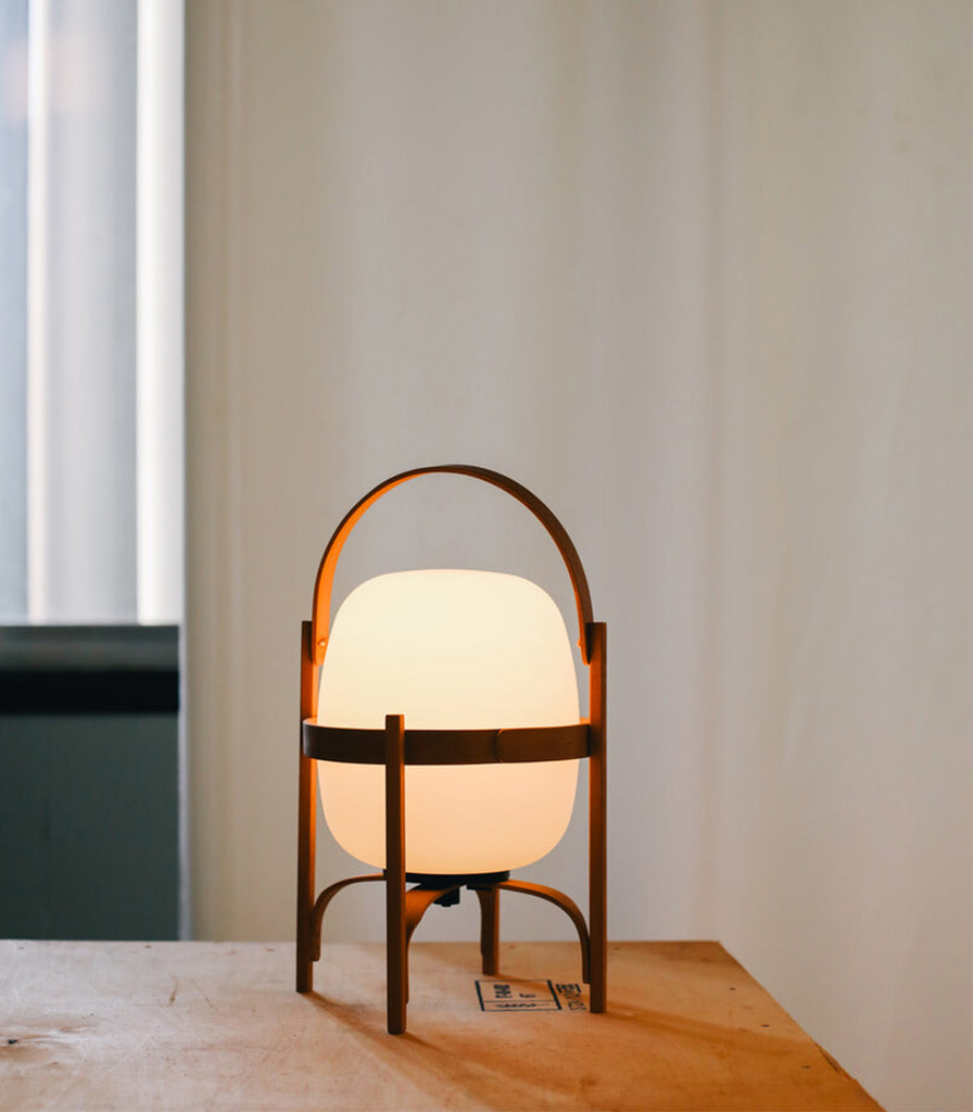 Santa & Cole Cestita Portable Table Lamp featured within interior space