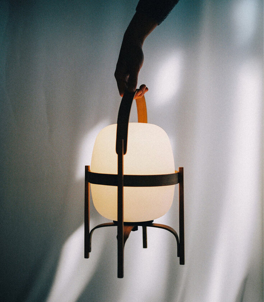 Santa & Cole Cestita Portable Table Lamp featured within interior space