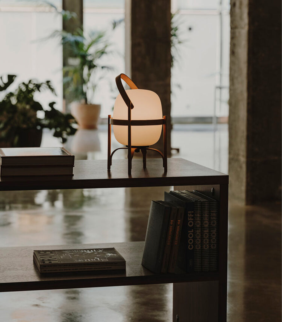 Santa & Cole Cestita Portable Table Lamp featured within interior space