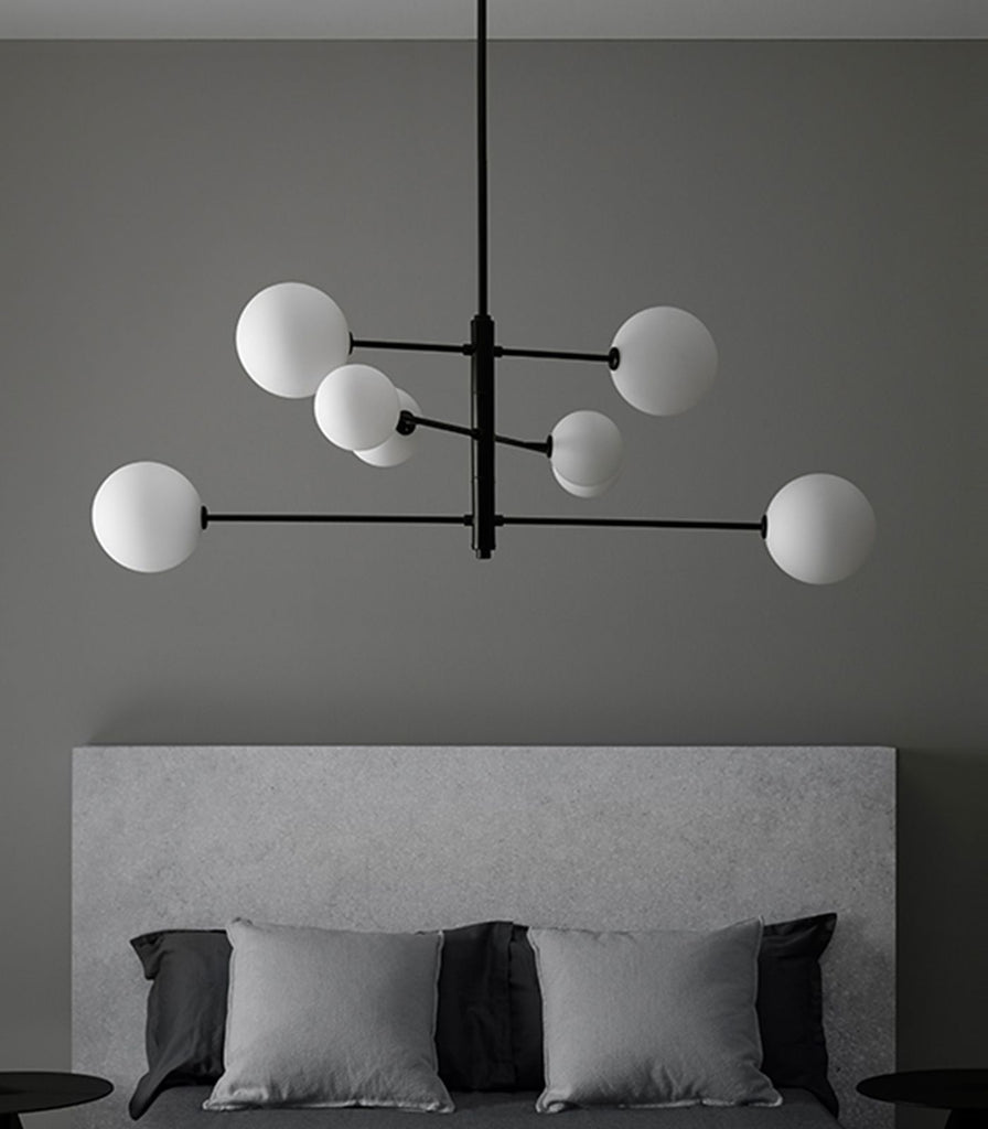 Aromas Atom Pendant Light hanging over bed