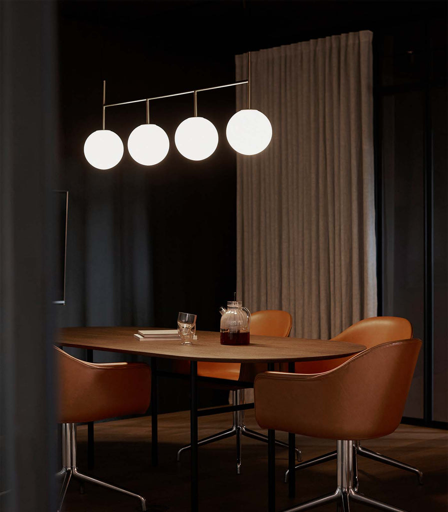 Menu Lighting TR Bulb Linear Pendant Light hanging over dining table