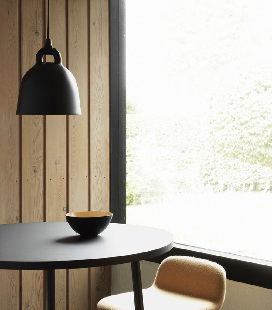 Normann Copenhagen Bell Pendant Light featured hanging over dining table