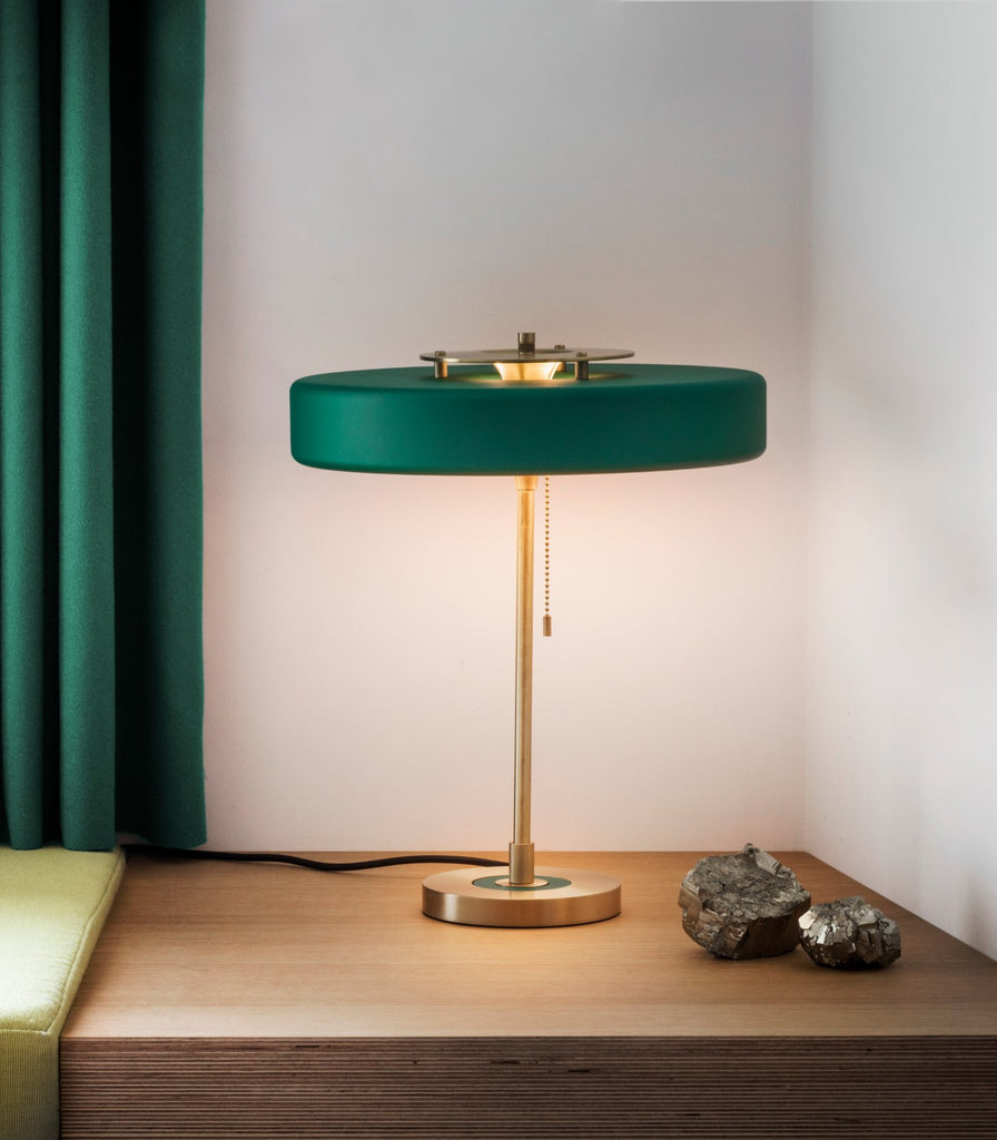 Bert Frank Revolve Table Lamp placed over table