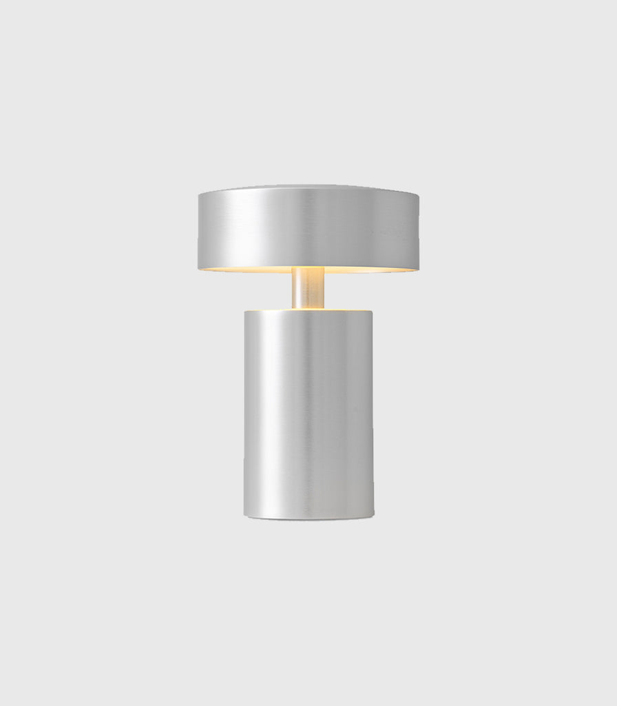 Menu Lighting Column Portable Table Lamp featured within interior space