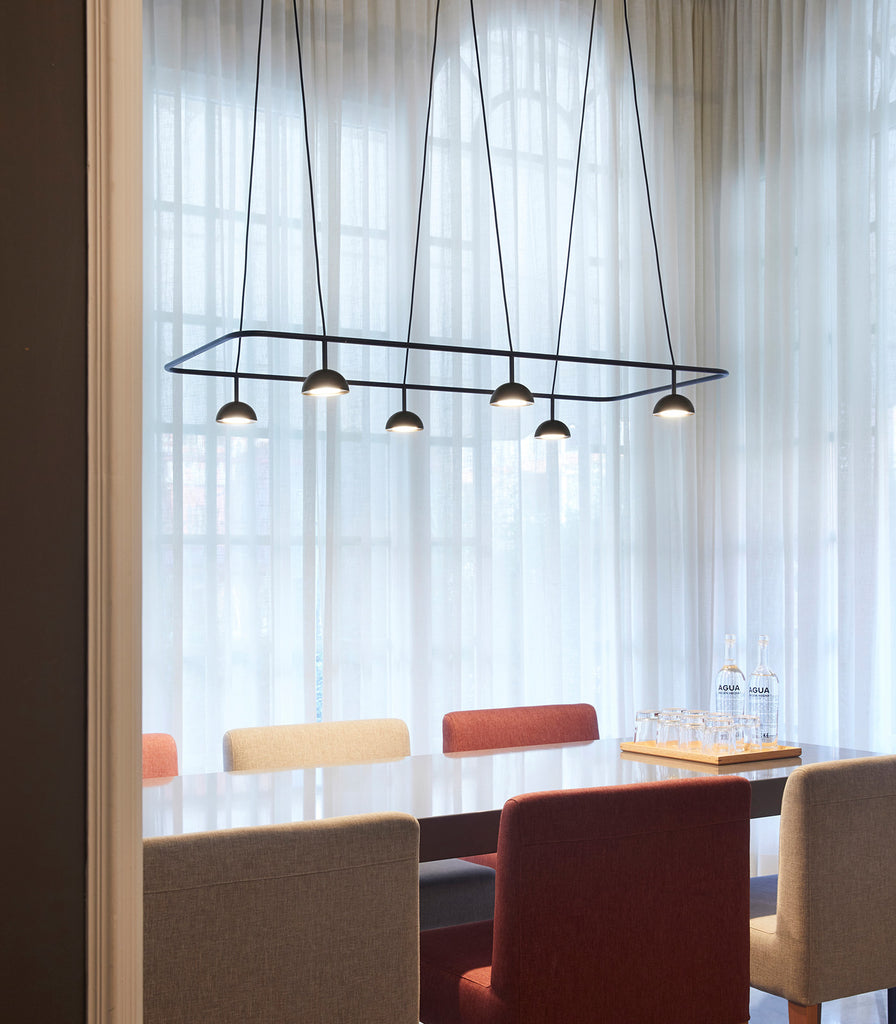 Estiluz Cupolina Linear Pendant Light hanging over dining table