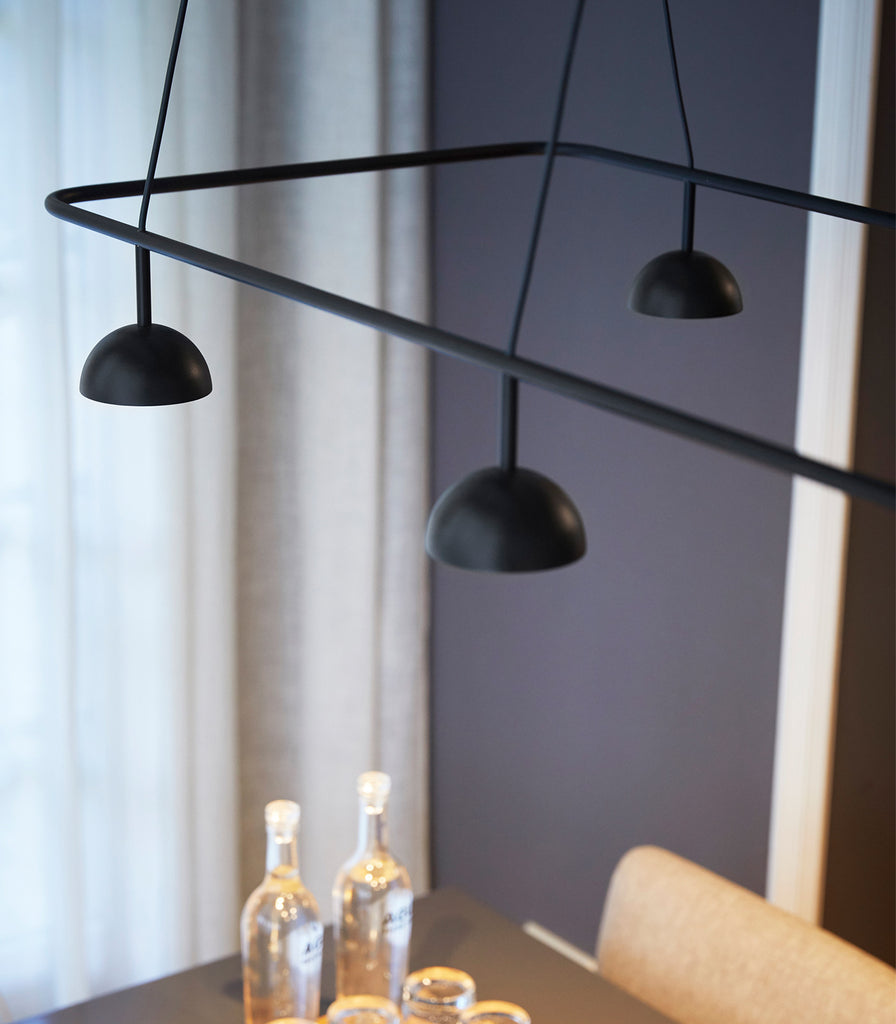 Estiluz Cupolina Linear Pendant Light hanging over dining table