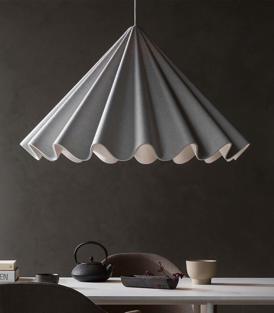 Menu Lighting Dancing Pendant Light hanging over dining table