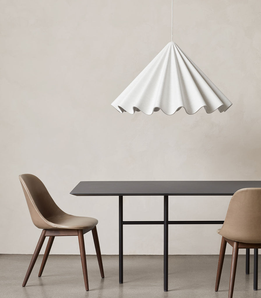 Menu Lighting Dancing Pendant Light hanging over dining table