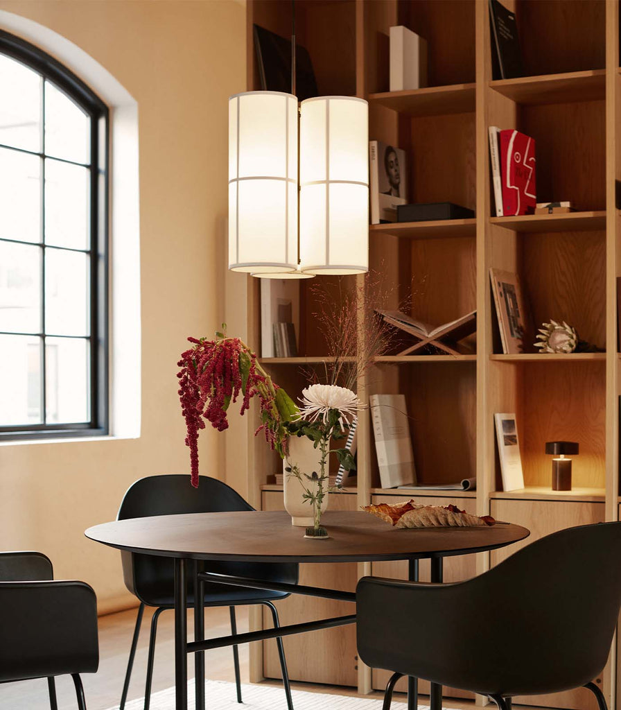 Menu Lighting Hashira Small Cluster Pendant Light hanging over dining table