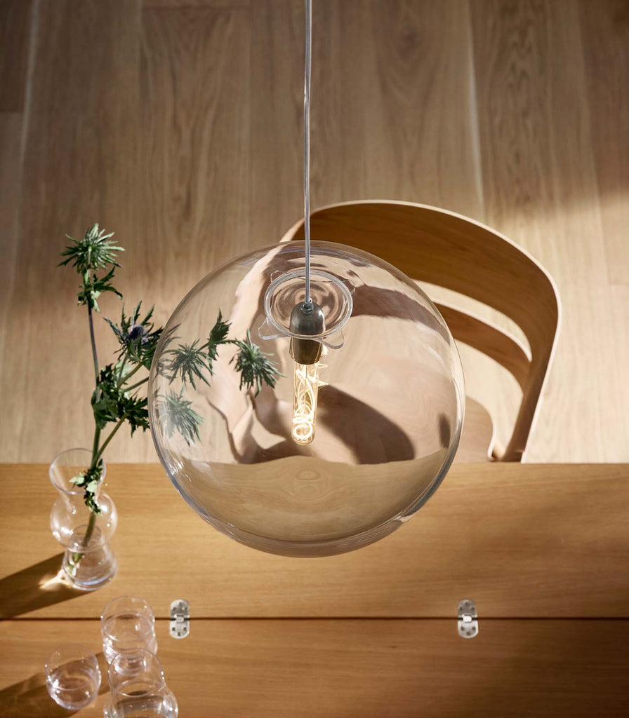 Nordic Fusion Luna Clear Pendant Light hanging over dining table