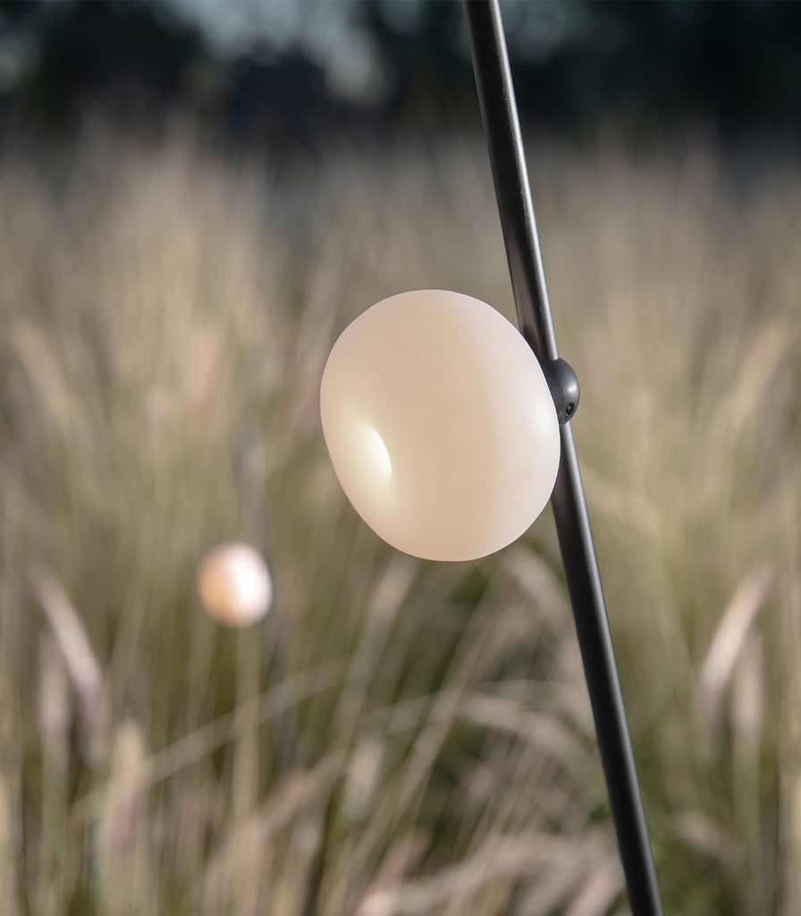 Karman Pois Floor Lamp featured within a outdoor space