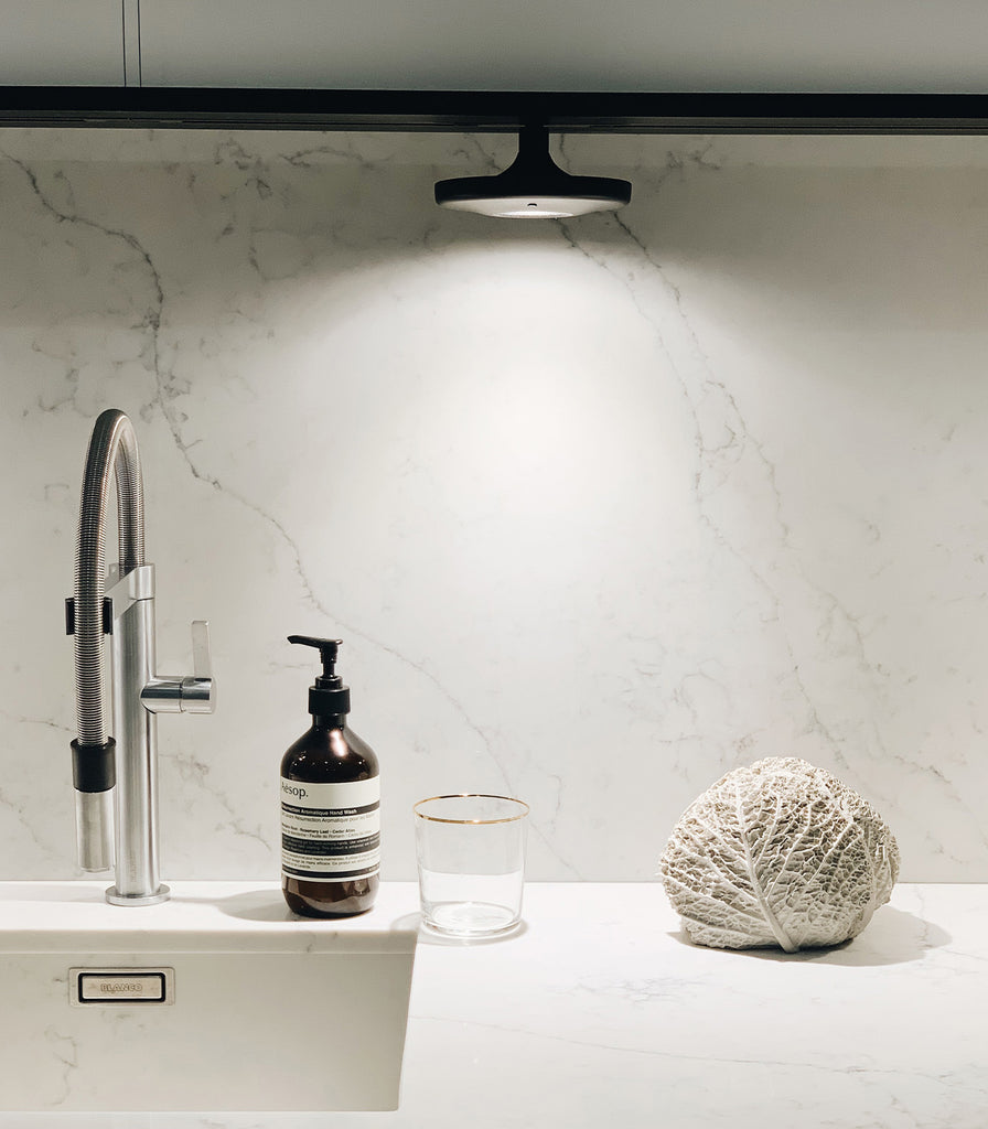 Estiluz Button 4lt Linear Pendant Light featured within interior space