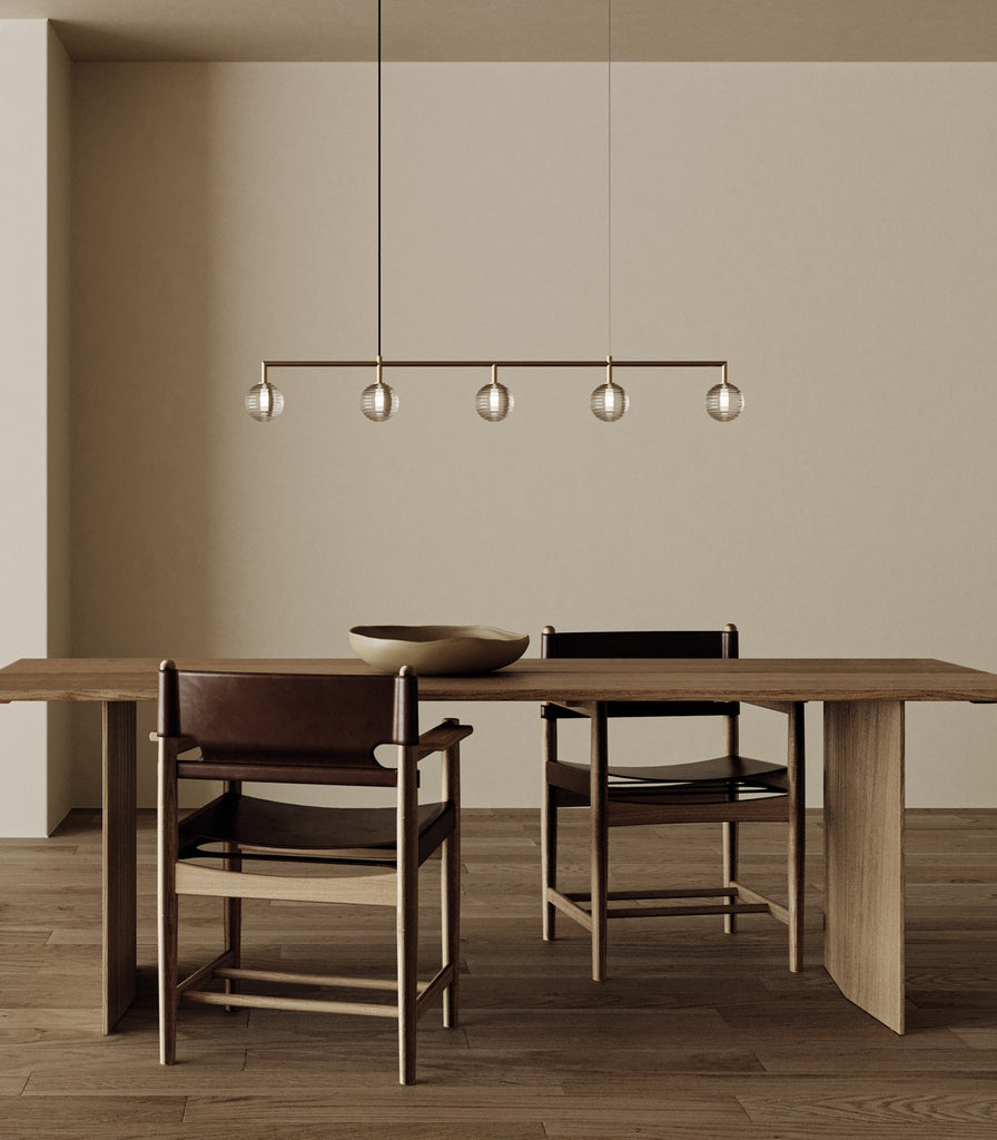 Aromas Doul Linear Pendant Light hanging over dining table