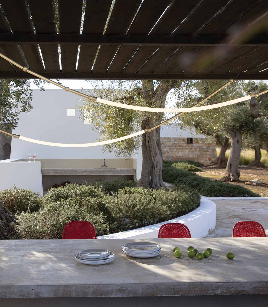 Karman Leda Outdoor Curve Pendant Light featured within a interior space