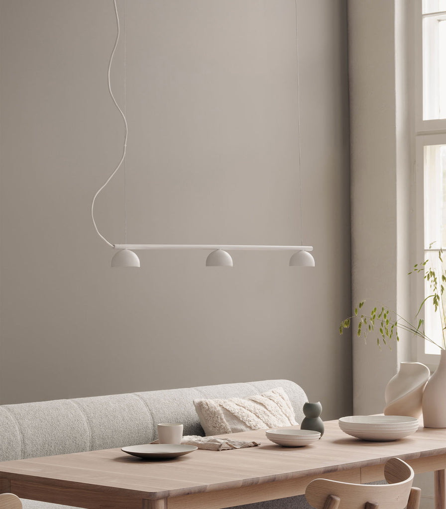 Northern Blush 3lt Rail Pendant Light featured within a interior space