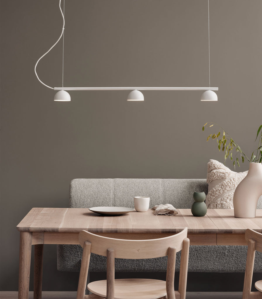 Northern Blush 3lt Rail Pendant Light hanging over a dining table