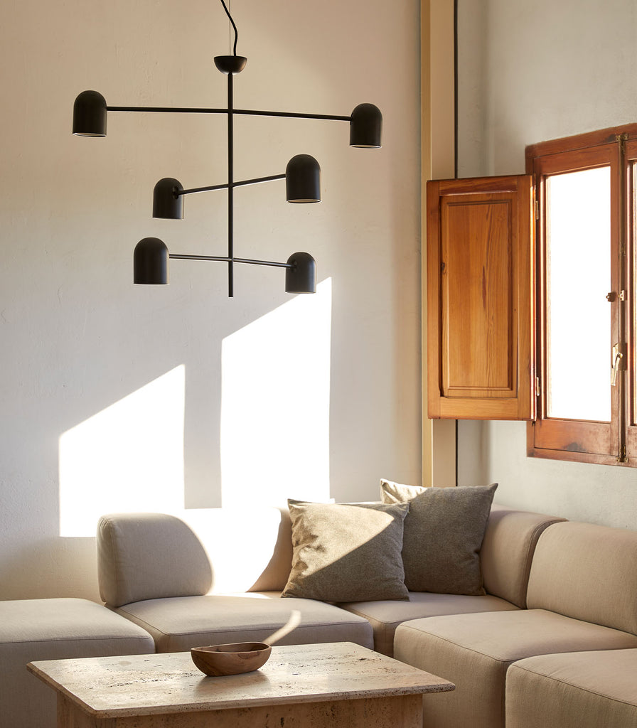 Aromas Pipe Pendant Light hanging in a living room