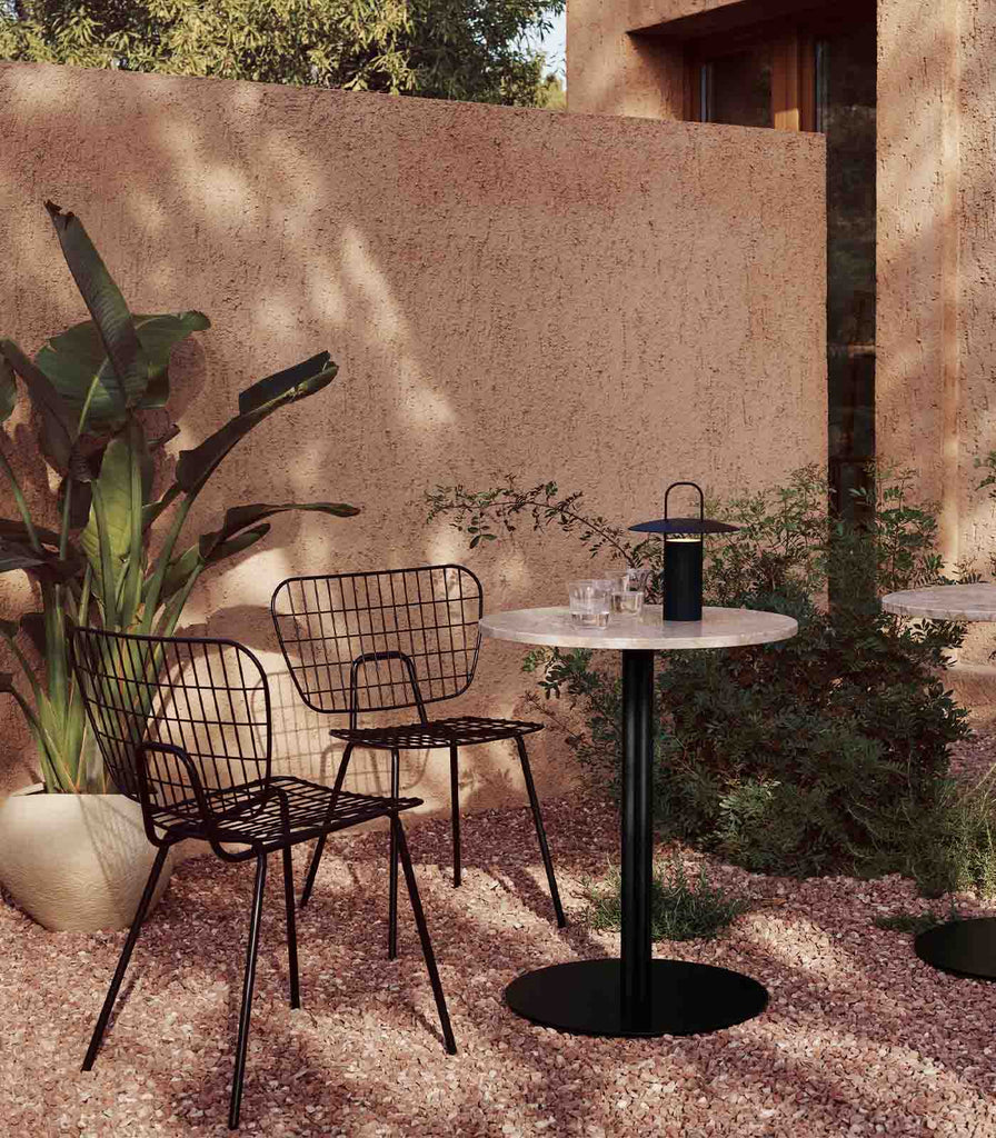 Menu Lighting Ray Portable Table Lamp featured within outdoor space