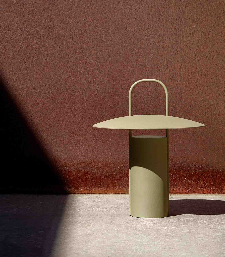 Menu Lighting Ray Portable Table Lamp featured within interior space