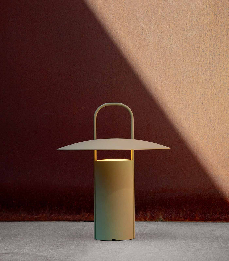 Menu Lighting Ray Portable Table Lamp featured within interior space