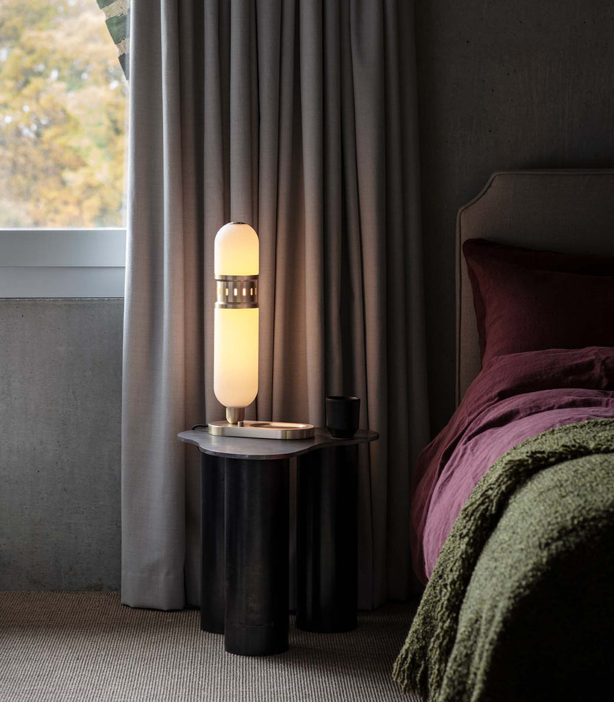 Bert Frank Occulo Side Table Lamp placed beside a bed