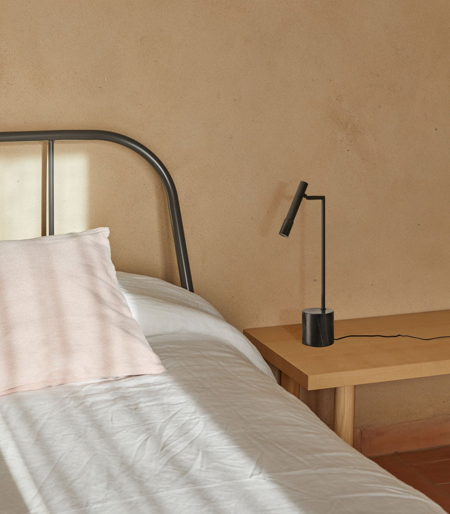 Aromas Ycro Table Lamp placed beside a bed