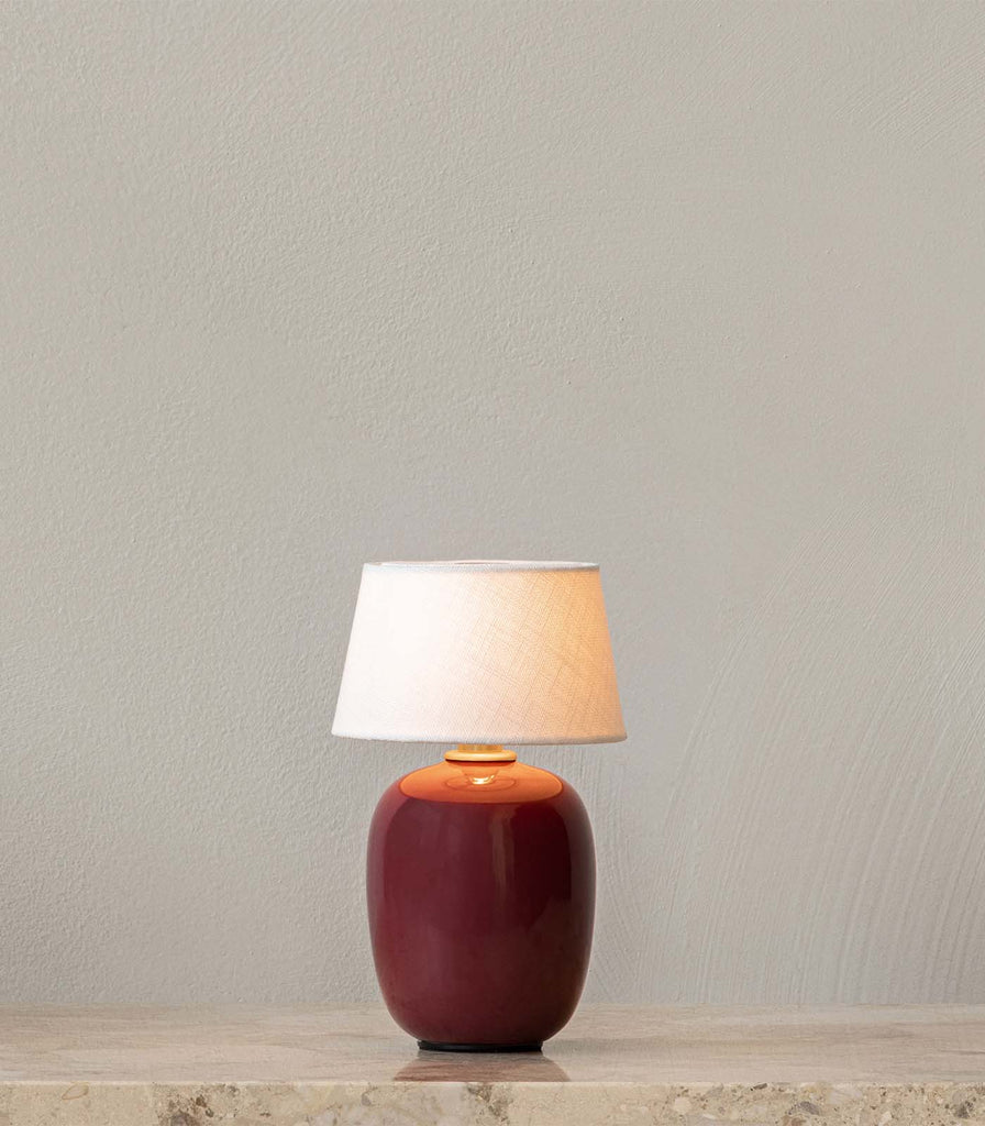 Menu Lighting Torso Portable Table Lamp featured within interior space