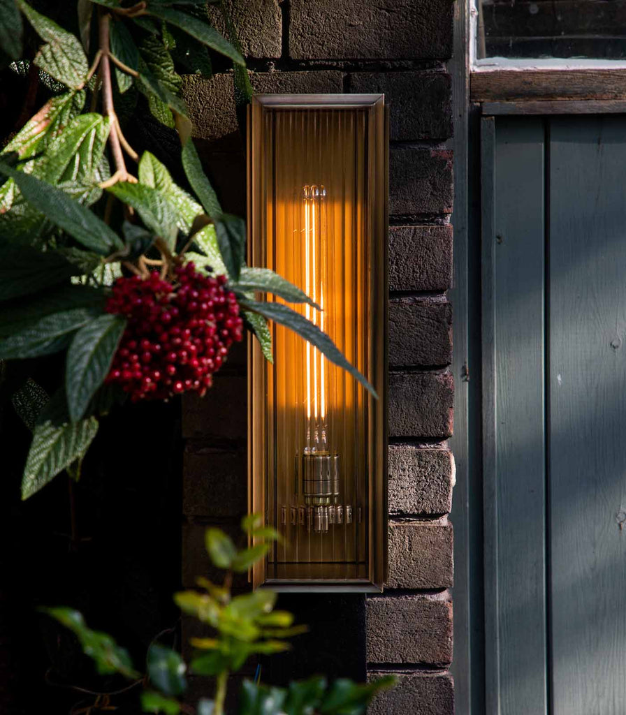  J. Adams & Co. Ash Reeded Wall Light in Bronze featured in an interior space