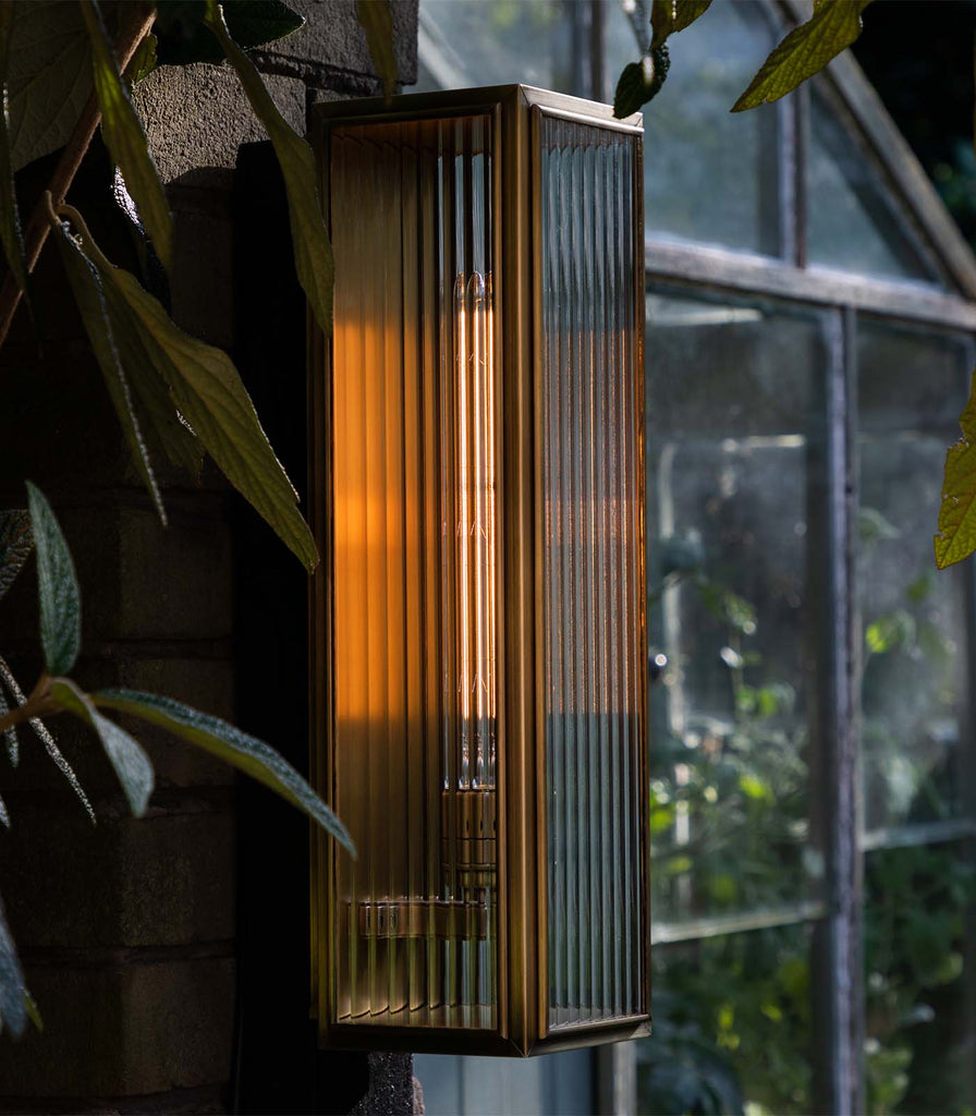  J. Adams & Co. Ash Reeded Wall Light in Bronze featured in an interior space