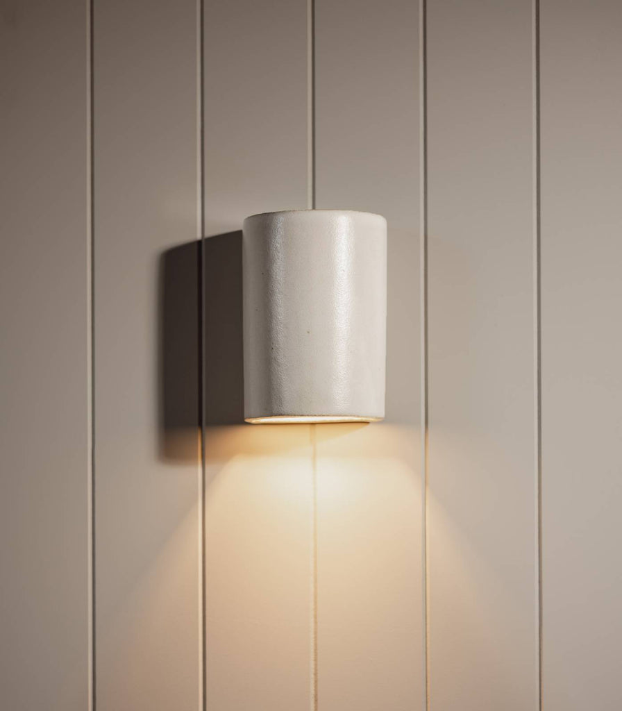 We Ponder Dawn Short Outdoor Wall Light in Eggshell White turned on