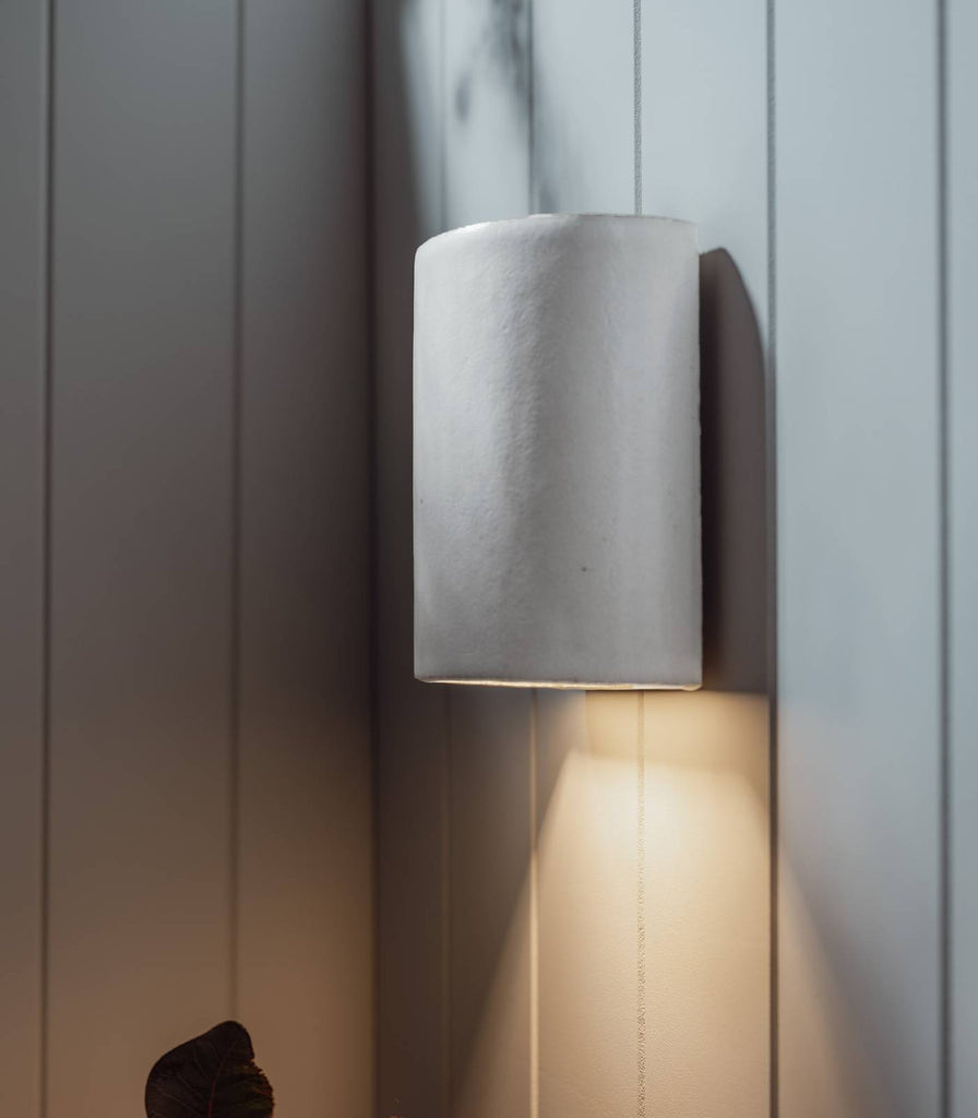 We Ponder Dawn Short Outdoor Wall Light in Eggshell White turned on