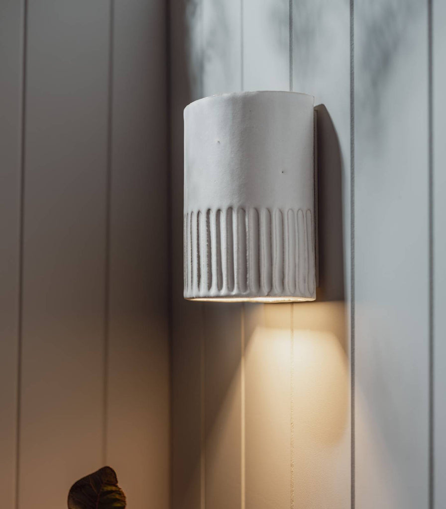 We Ponder Day Short Outdoor Wall Light in Eggshell White turned on