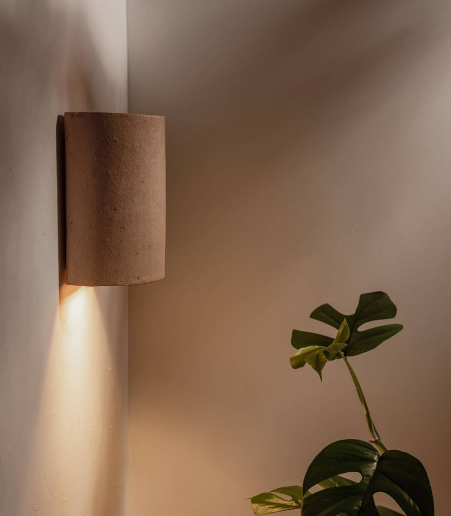 We Ponder Nudie Wall Light in Raw Clay finish in an interior setting