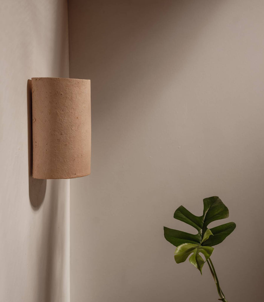 We Ponder Nudie Outdoor Wall Light in Raw Clay finish in interior setting